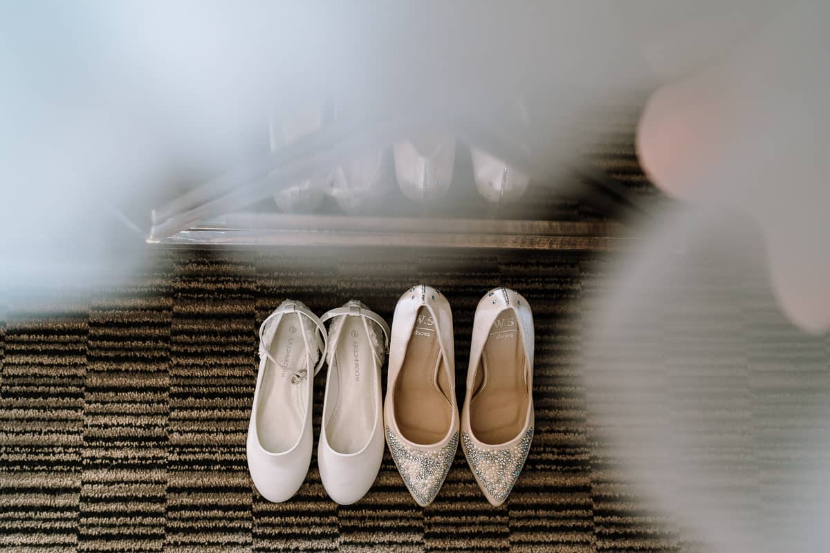 Bride and Flower Girl Shoes reflected at Abbey House Hotel, Barrow in Furness