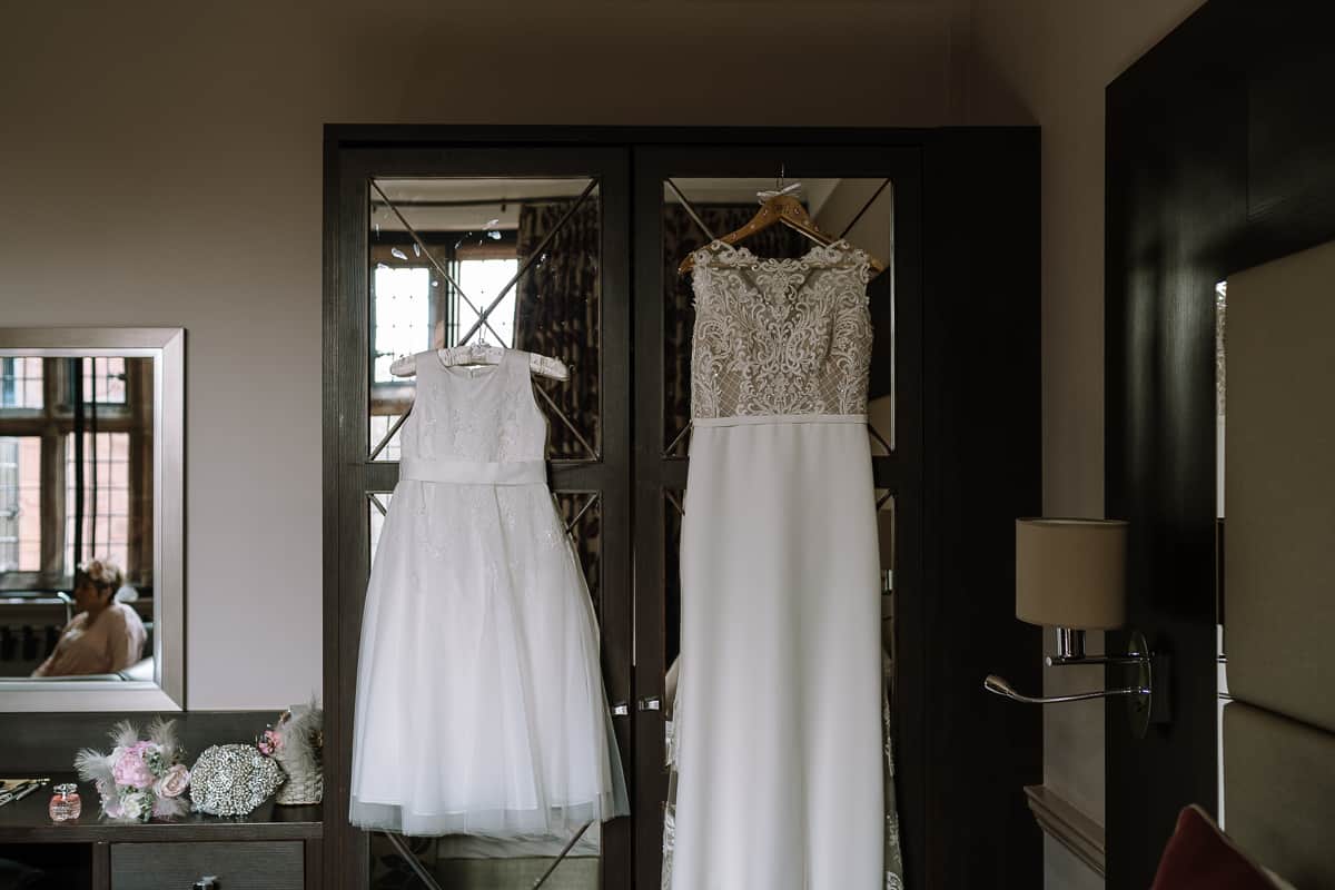 Bride and Flower Girl Dresses hanging in Suite at Abbey House Hotel Barrow in Furness