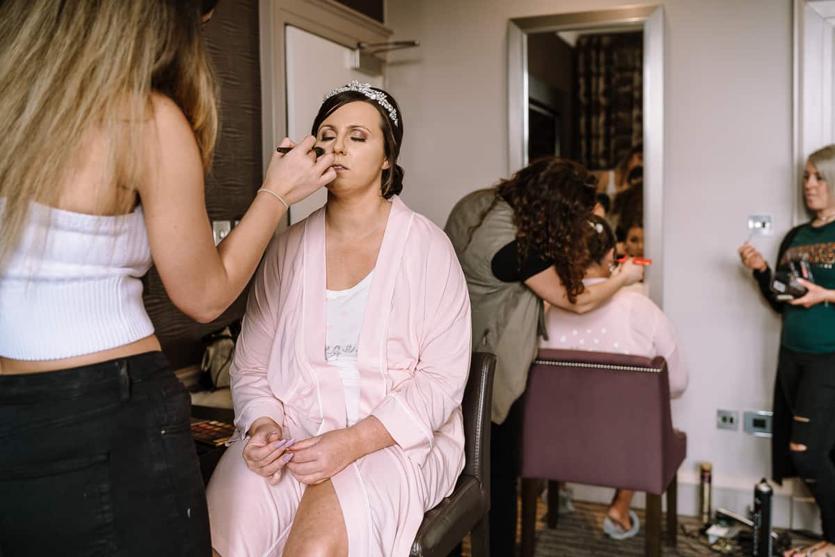 Bride having her makeup done before she gets married at Abbey House Hotel 