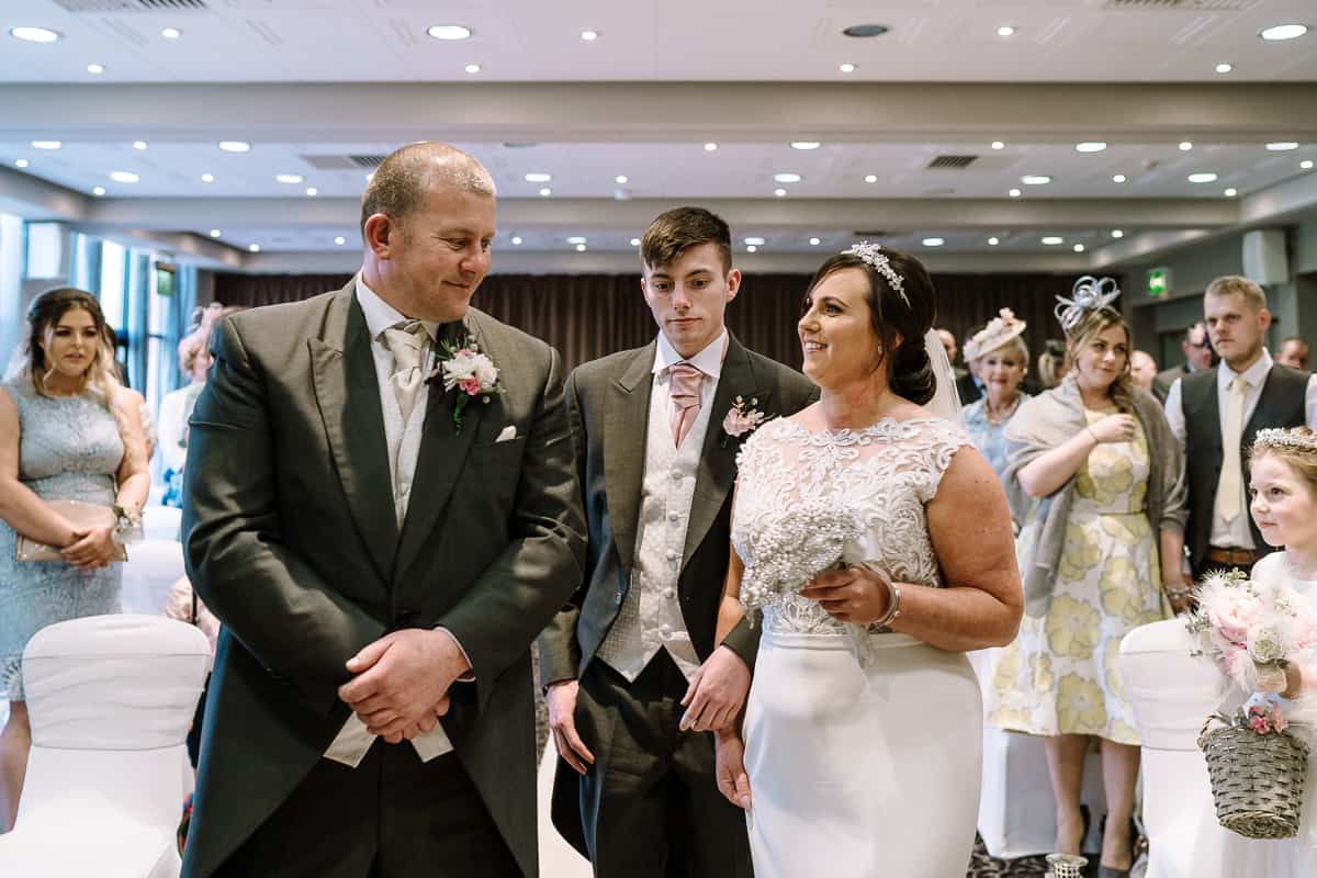 The first look from the groom at the bride on their wedding day, Abbey House Hotel, Barrow-in-Furness