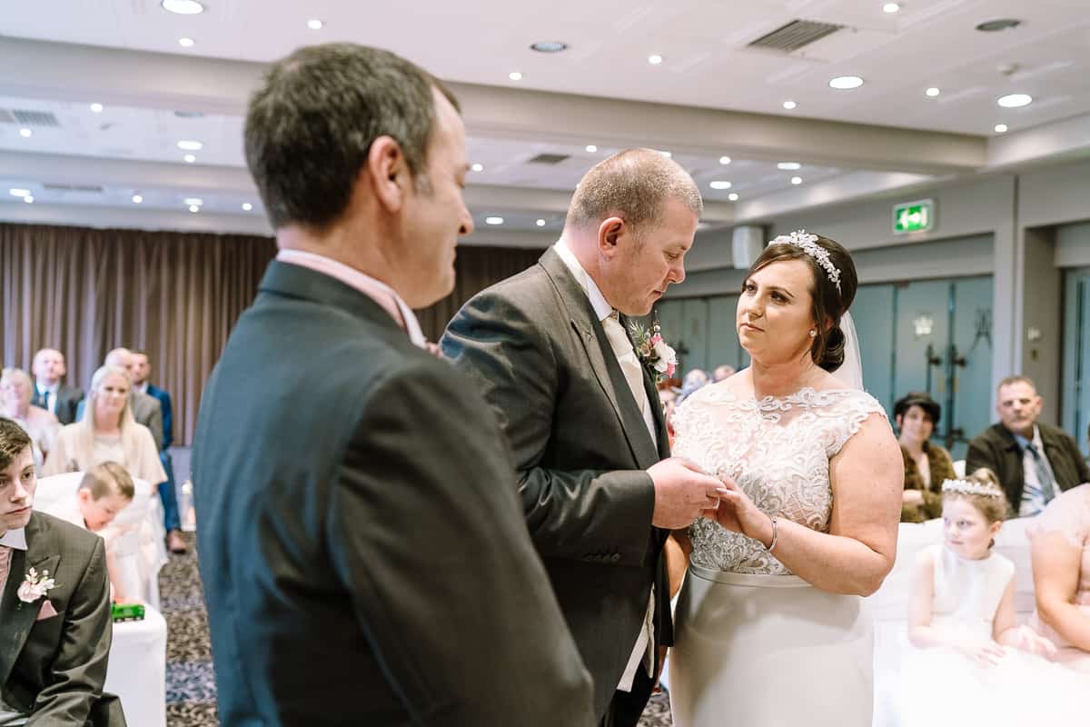 Exchanging the rings during the wedding ceremony at Abbey House Hotel, Barrow-in-Furness