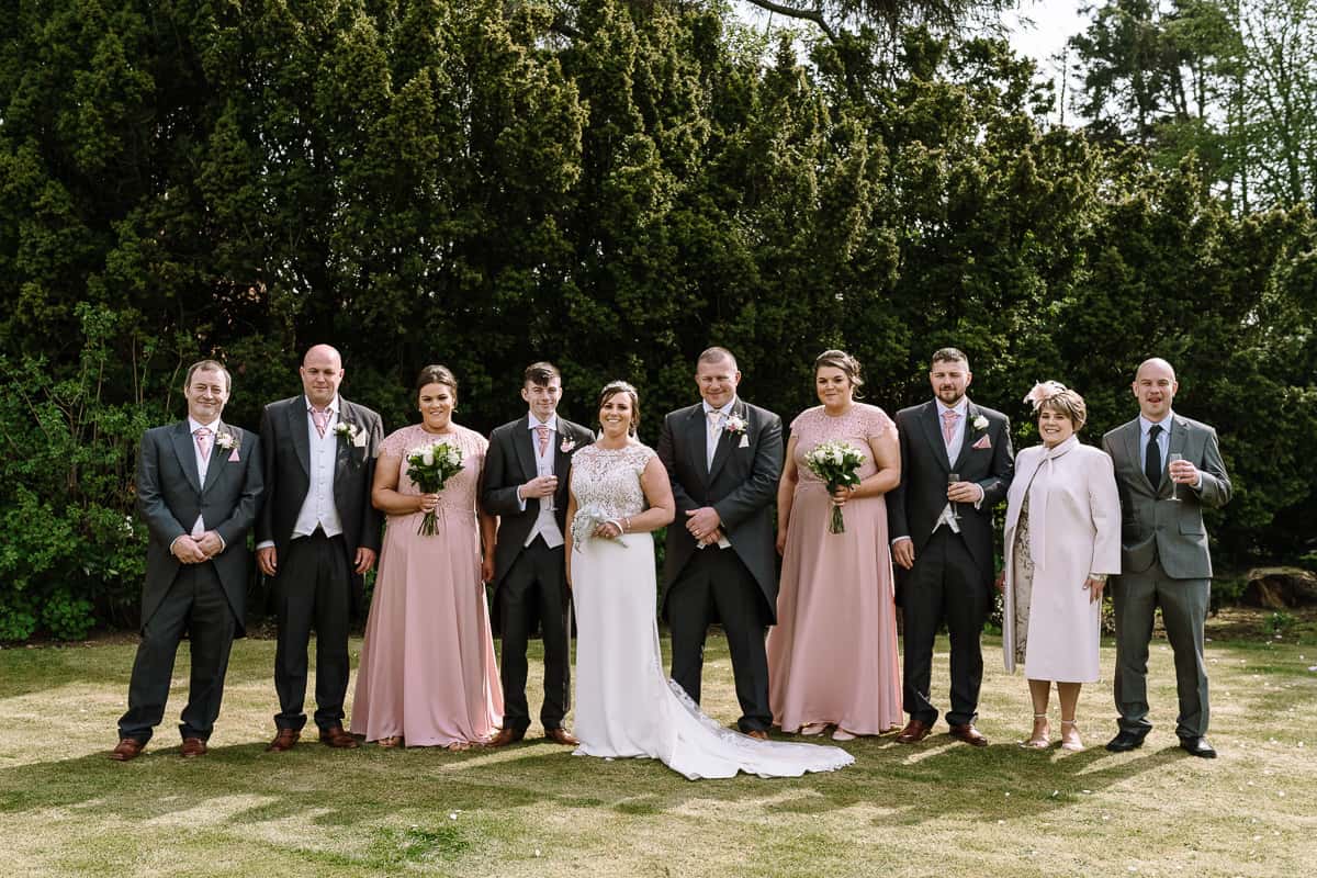 The Bridal Party in pink and grey on the lawns of Abbey House Hotel, Barrow-in-Furness