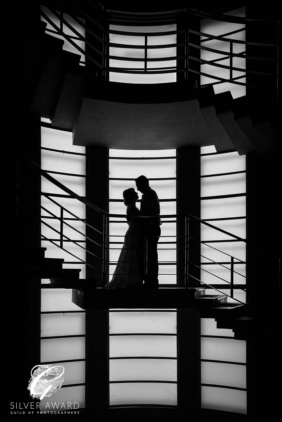 Bride and groom standing on the spiral staircase at the Midland Hotel, Morecambe