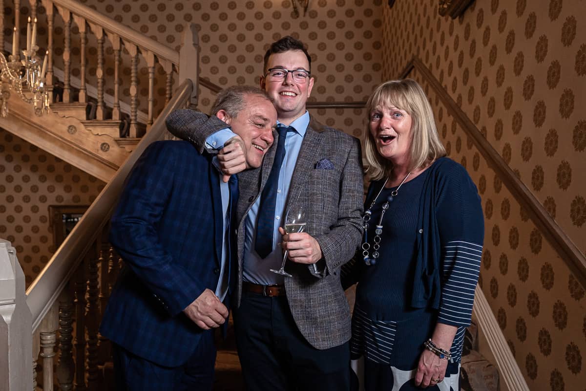 Fun family portrait of a family of three on the staircase at the Grosvenor Hotel in Chester, Cheshire
