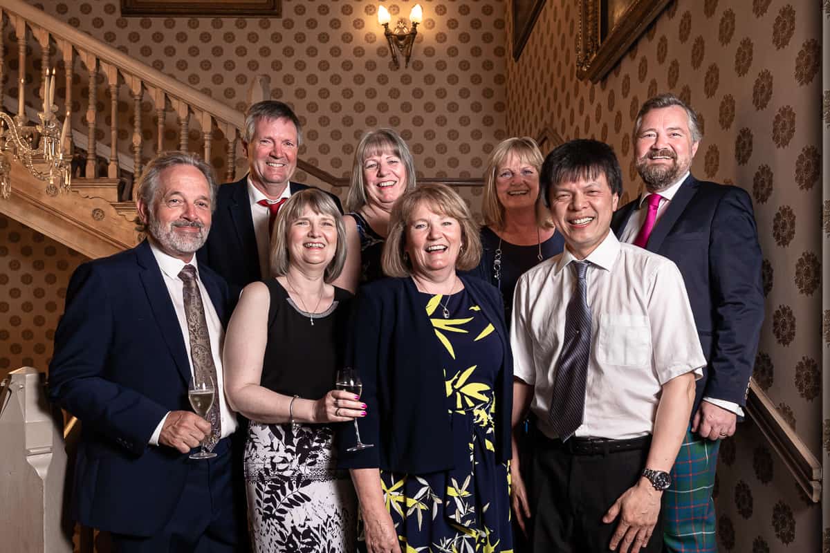Photography of a happy family group on the staircase of the Grosvenor Hotel in Chester